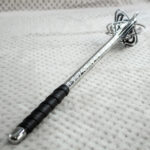 Pernach viewed along its patterned shaft from the black grip toward the openwork head