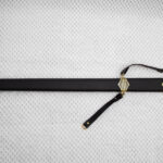 Full side view of Sviatoslav's sword in a black scabbard with patterned fittings and carrying straps