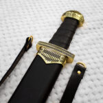 Close-up of Sviatoslav's sword in its scabbard, showing the black grip, patterned guard and pommel