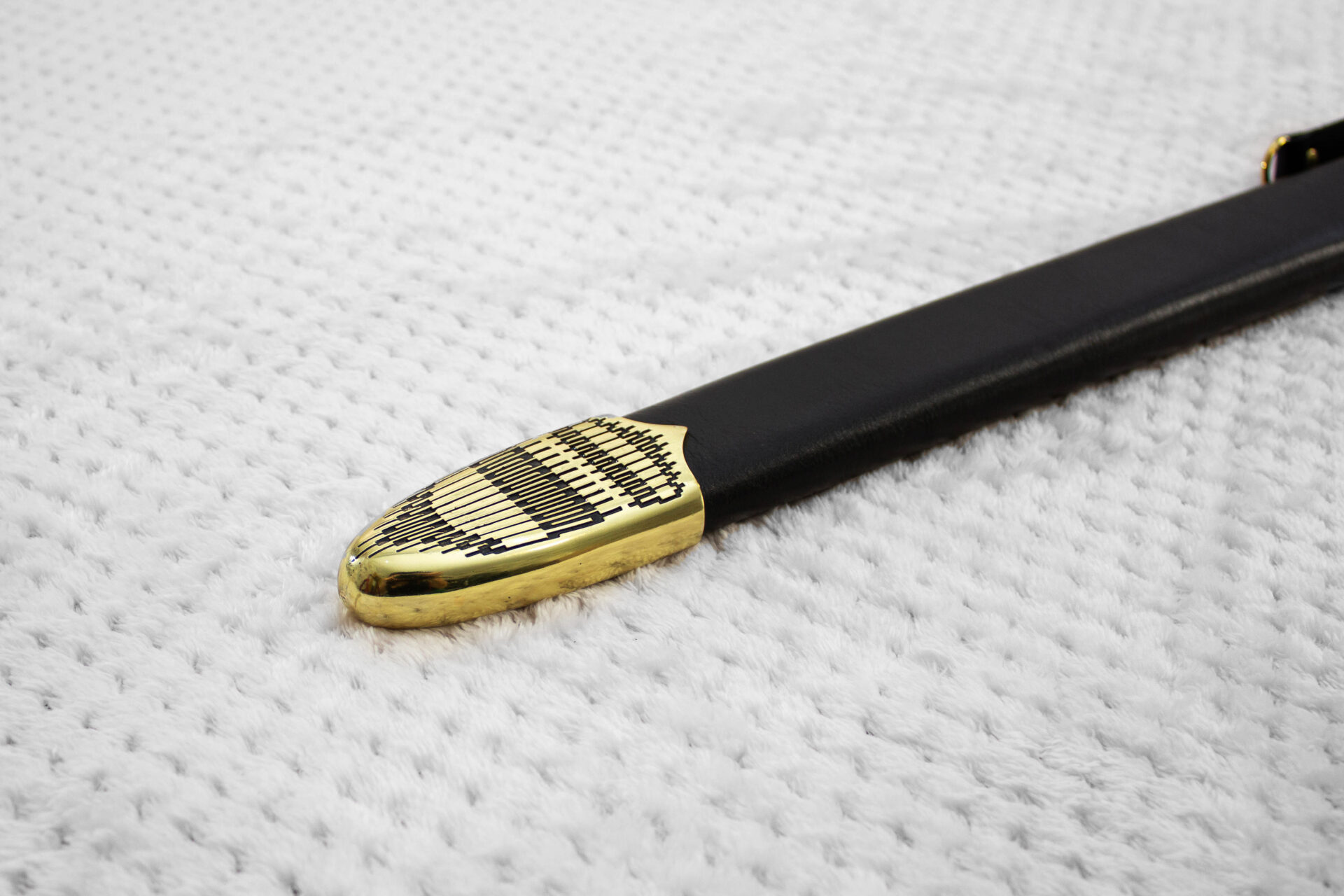 Close-up of the geometric-patterned tip on the black scabbard for Sviatoslav's sword