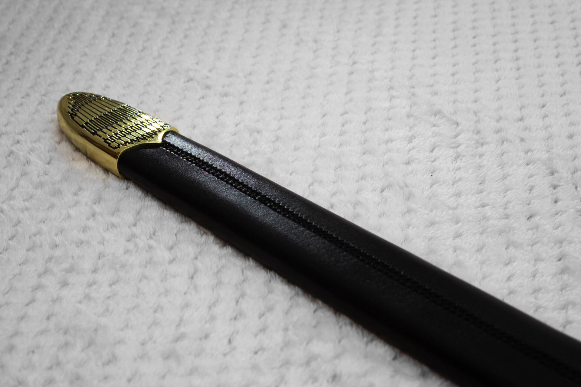 Reverse side of Sviatoslav's sword scabbard, with a central stitched seam and geometric-patterned tip