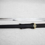Full-length Sviatoslav's sword beside its black scabbard with patterned fittings and carrying straps