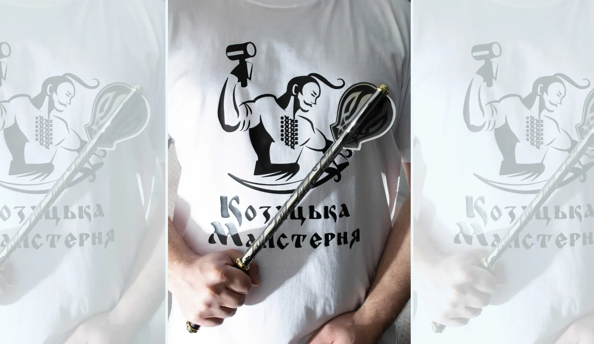 Pernach held diagonally in front of a white Cossack Workshop logo shirt