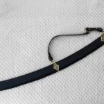 SiCh-KzO saber in a black scabbard with decorated fittings, viewed at an angle