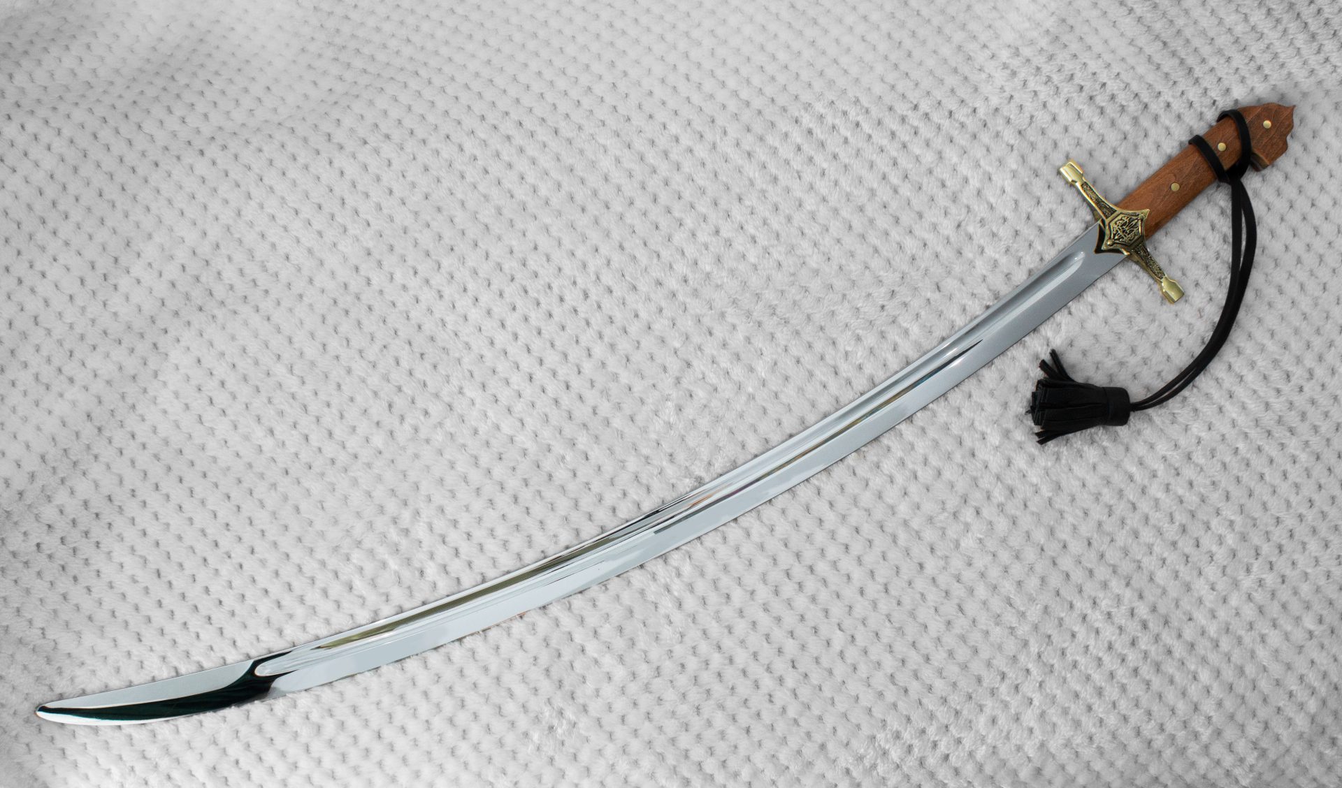 Curved SiCh-KzO saber blade with a long fuller, viewed from the tip