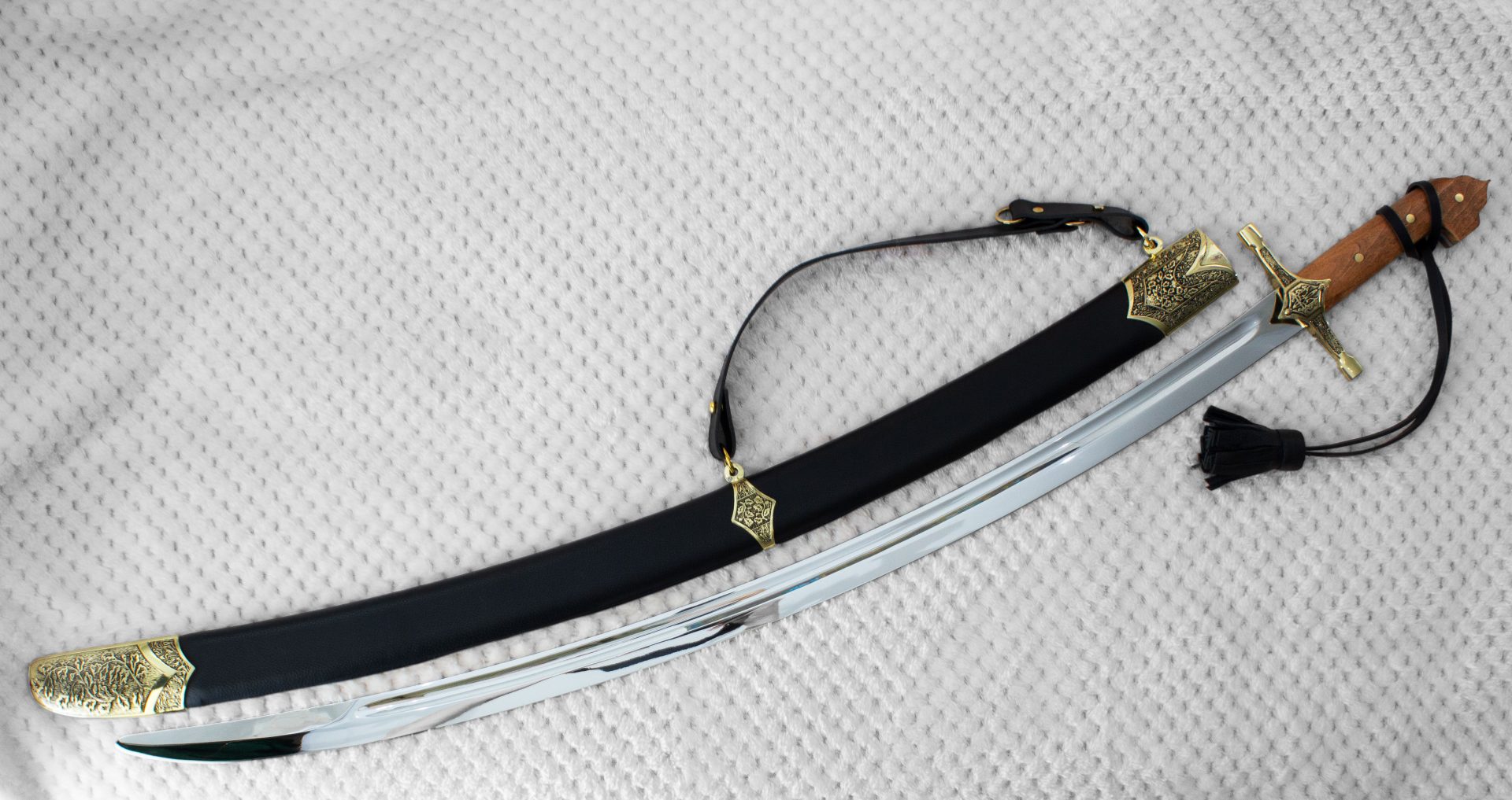 SiCh-KzO saber beside its black scabbard, viewed from the blade tip