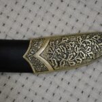 Close-up of the leaf-pattern decoration on the SiCh-Sh scabbard tip