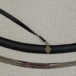 Unsheathed SiCh-Sh saber beside its black decorated scabbard, full side view