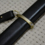 Close-up of the carrying strap ring and band on the Cossack shashka's black scabbard