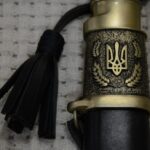 Trident within a wreath on the Cossack shashka's scabbard fitting, beside a black tassel