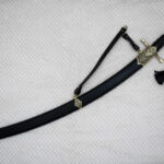 SiCh-Hetman saber in a black scabbard with decorated fittings, carrying strap and tassel