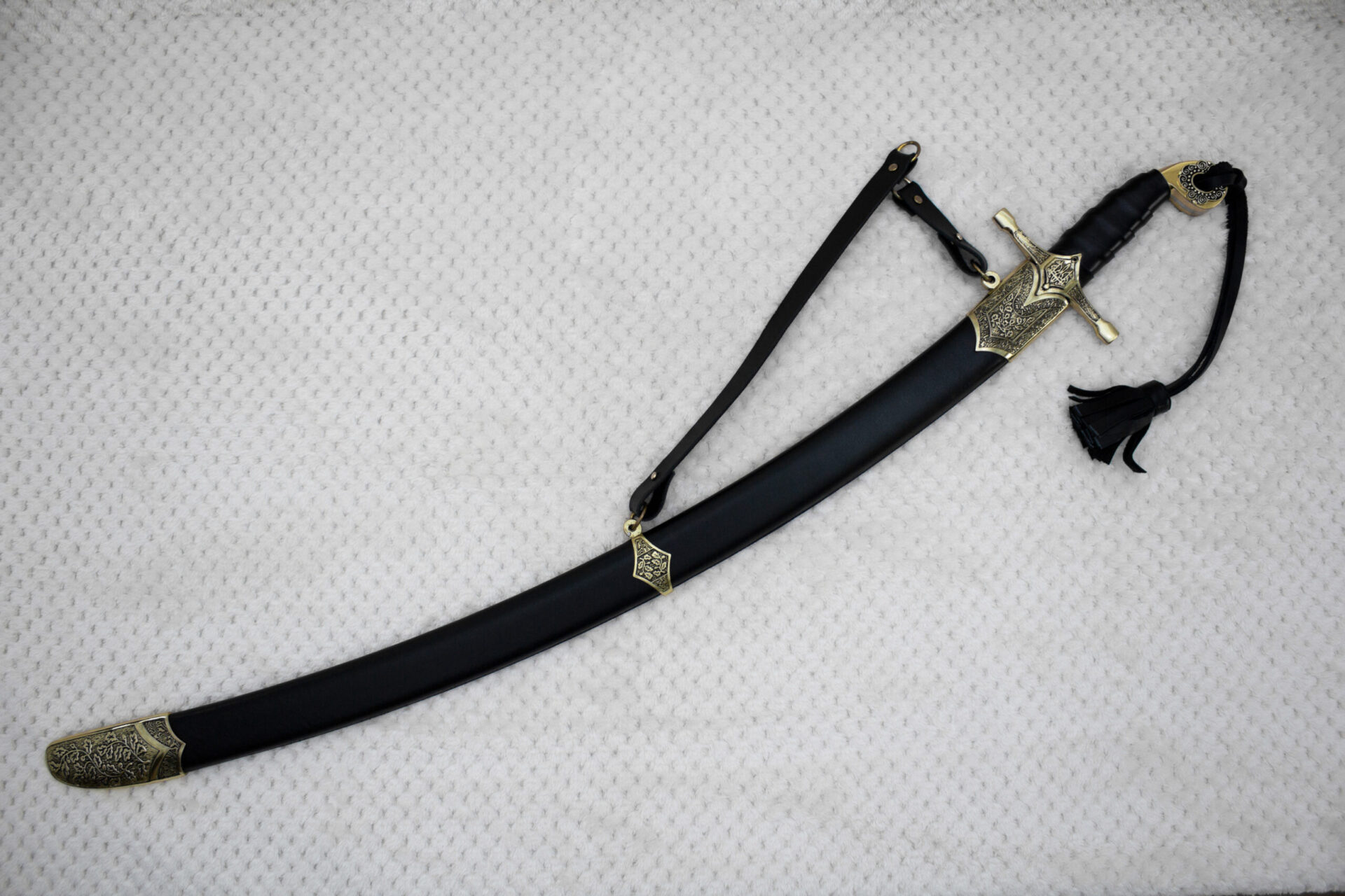 SiCh-Hetman saber in a black scabbard with decorated fittings, carrying strap and tassel