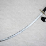 SiCh-Hetman saber viewed diagonally, showing its curved blade, black grip and hanging tassel