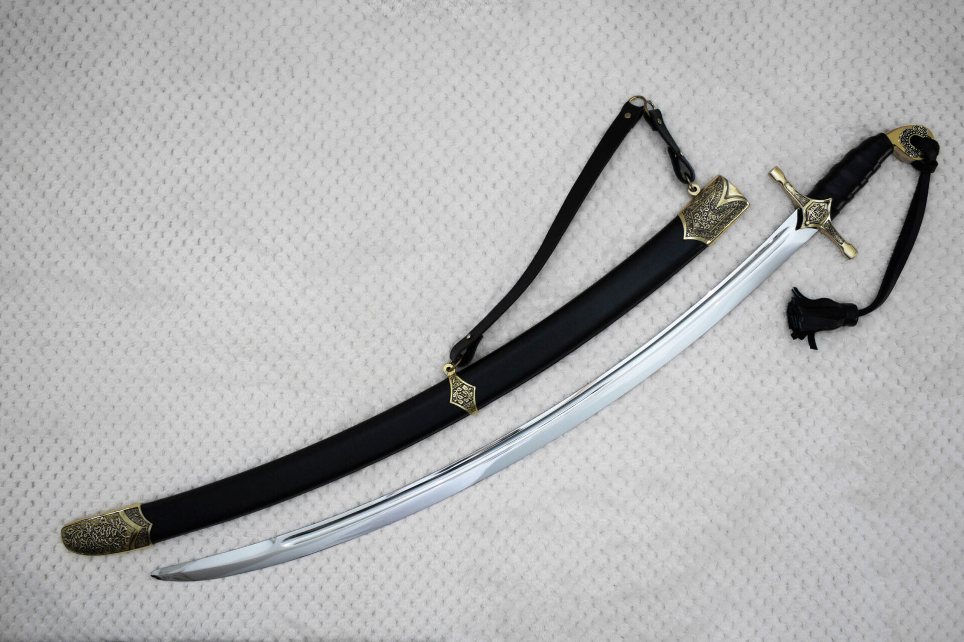 SiCh-Hetman saber and black scabbard arranged diagonally, with decorated guard, carrying strap and tassel