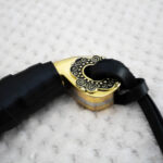 Close-up of the SiCh-Hetman saber pommel with spiral ornament and black tassel strap