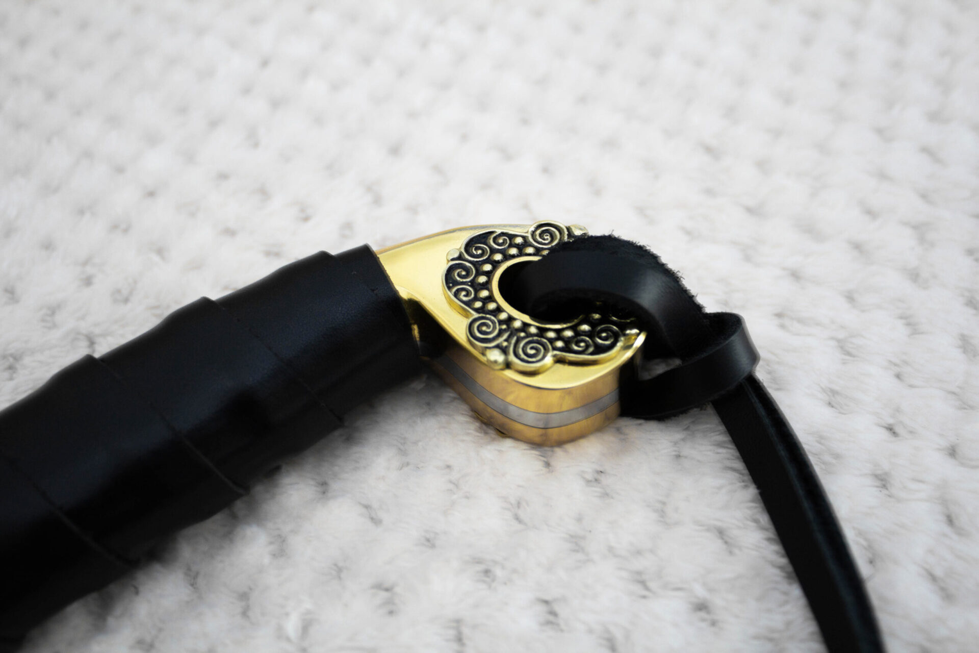 Close-up of the SiCh-Hetman saber pommel with spiral ornament and black tassel strap