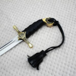 SiCh-Hetman saber hilt and blade base, with trident ornament on the guard and a black tassel strap