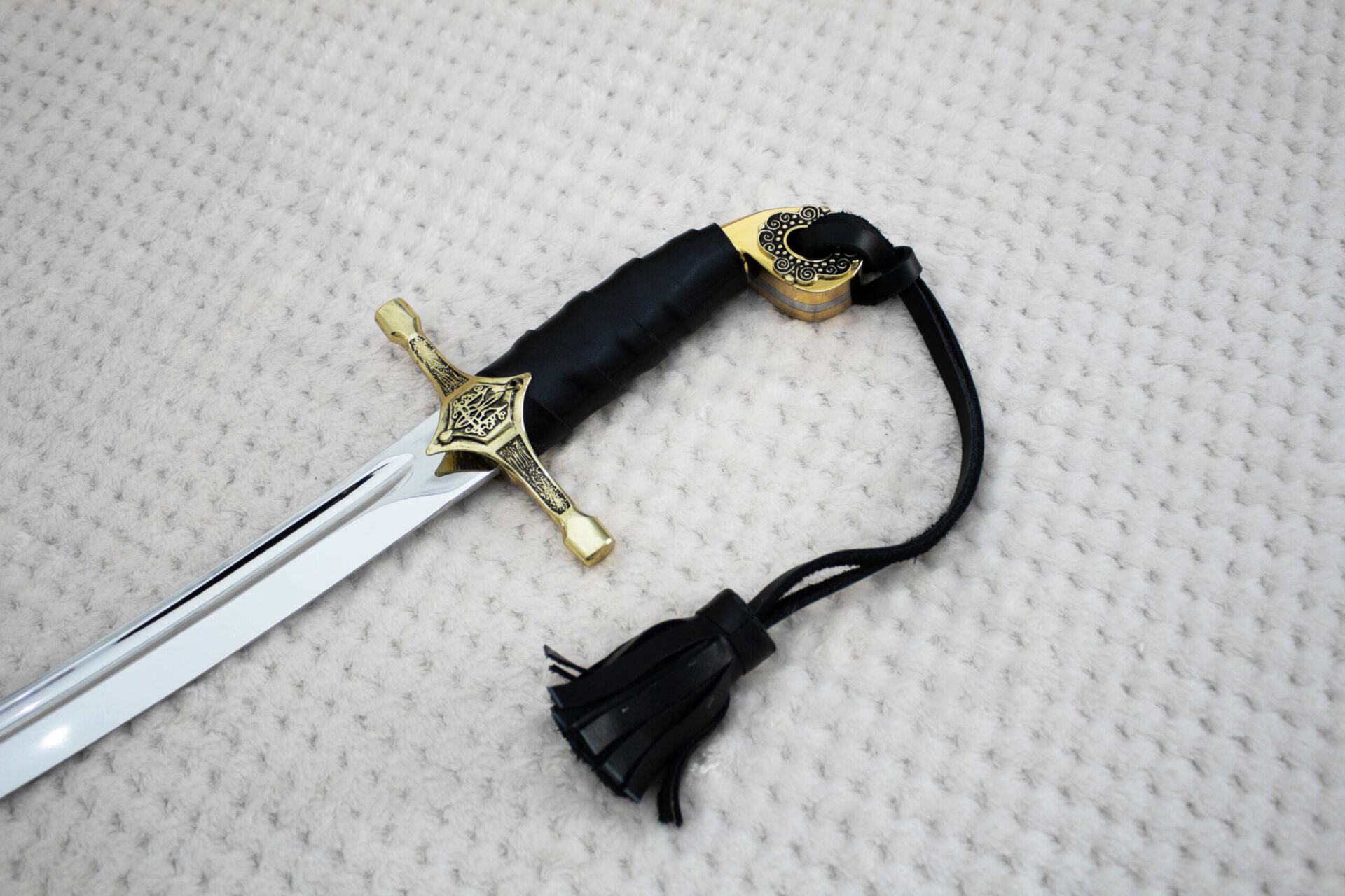 SiCh-Hetman saber hilt and blade base, with trident ornament on the guard and a black tassel strap