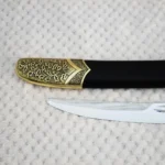 SiCh-Hetman saber blade tip beside the floral-patterned tip of its black scabbard