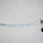 Full side view of the SiCh-Souvenir saber with curved fullered blade, decorated guard and reddish-brown grip