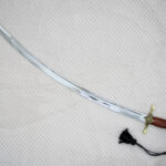 SiCh-Souvenir saber blade in diagonal view, showing its curved profile, tip and fuller