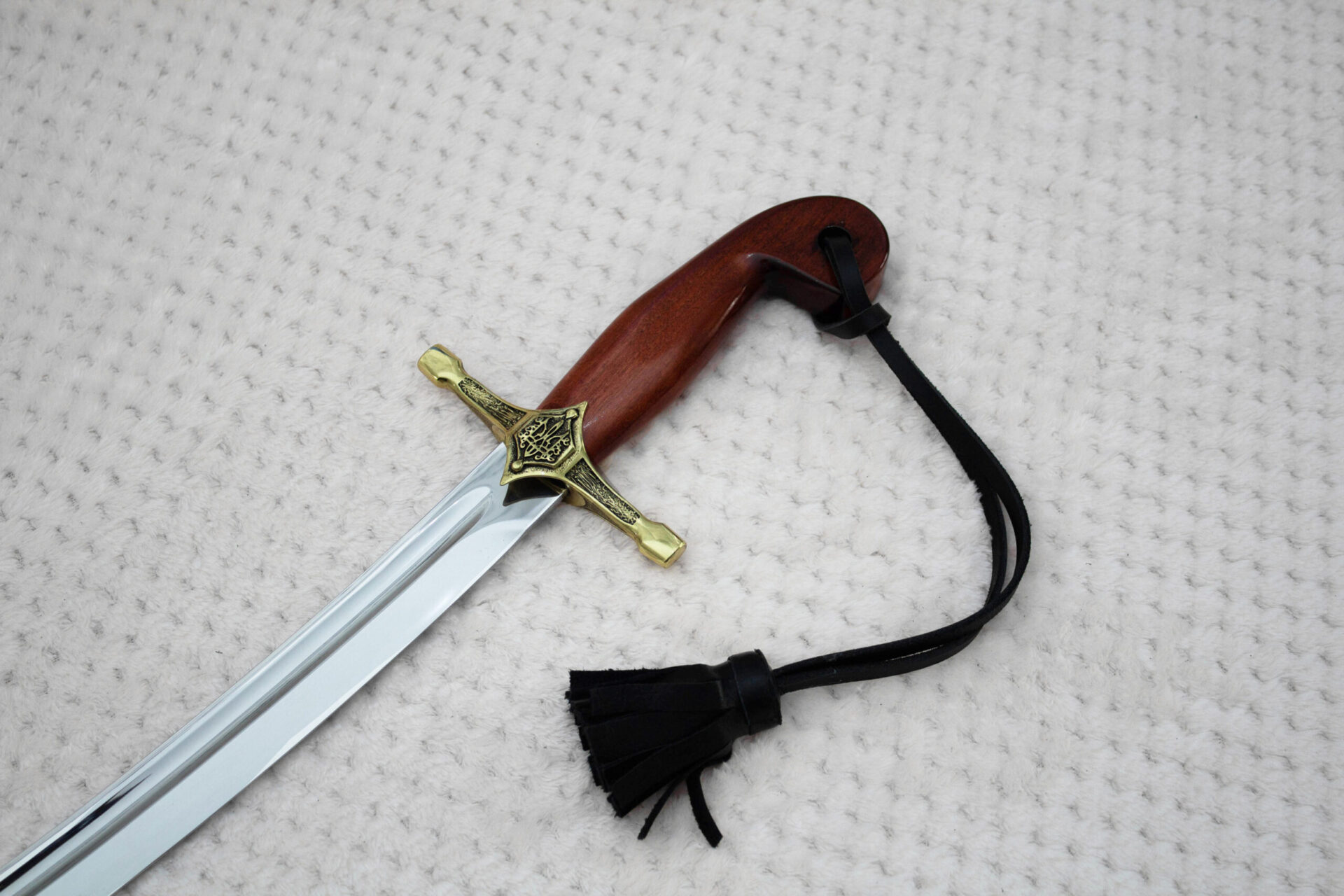 SiCh-Souvenir saber hilt and blade base with decorated guard, curved brown grip and black tassel strap
