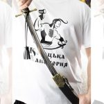SiCh-K saber held partly drawn from its black scabbard, with a tassel hanging from the hilt