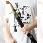 SiCh-K saber held in its black scabbard, showing the brown grip and hanging tassel