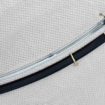 Dragoon saber with exposed blade beside its black scabbard, viewed at an angle