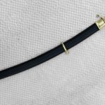 Dragoon saber in a black scabbard with metal fittings and a suspension ring