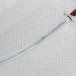 Curved Dragoon saber blade with a long fuller and knuckle guard, viewed at an angle