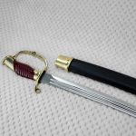 Dragoon saber with a red-brown grip and curved knuckle guard beside its black scabbard