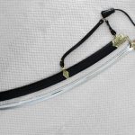 SiCh-K saber beside its black scabbard and suspension strap, viewed from the tip