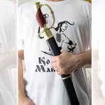 Dragoon saber held in its black scabbard, showing the ribbed grip and knuckle guard